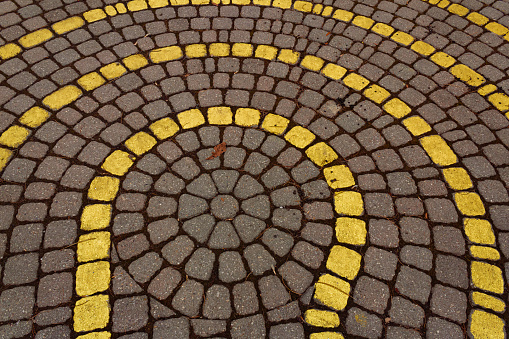 Yellow and red bricks in a symmetrical circular pattern