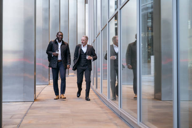 istock Business associates walking and talking on coffee break 1219154399