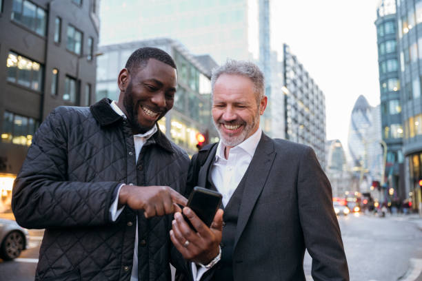 istock African businessman sharing photos with Caucasian associate 1219154418