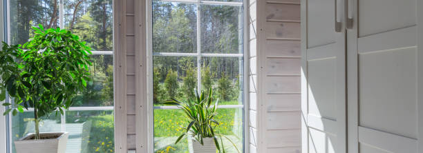 istock Bright photo studio interior with big window, high ceiling, white wooden floor 1219154948
