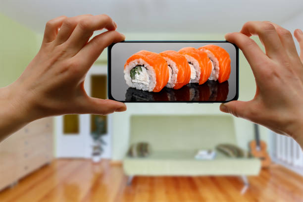 istock Order Philadelphia sushi set. Using mobile phone app from home. 1219155723