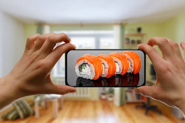 istock Order Philadelphia sushi set. Using mobile phone app from home. 1219155725