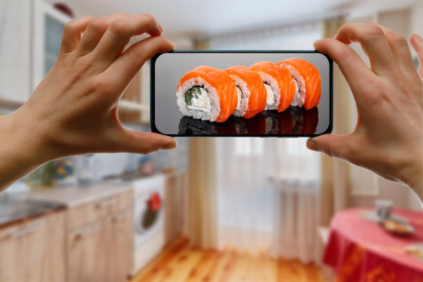 istock Order Philadelphia sushi set. Using mobile phone app from home. 1219155732