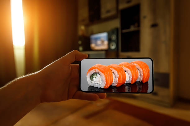 istock Order Philadelphia sushi set. Using mobile phone app from home. 1219155736