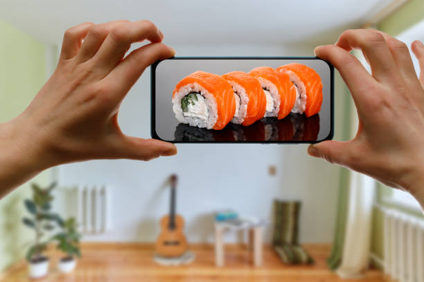 istock Order Philadelphia sushi set. Using mobile phone app from home. 1219155738