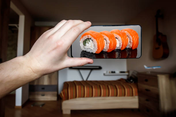 istock Order sushi set via the mobile app on your smartphone from home. 1219155739