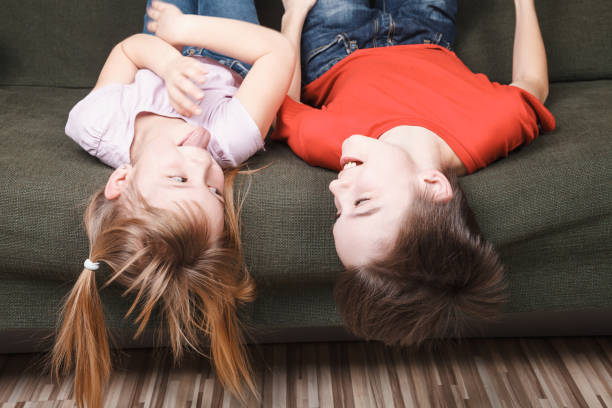 istock Siblings happy staying together at home during self-isolation 1219156032