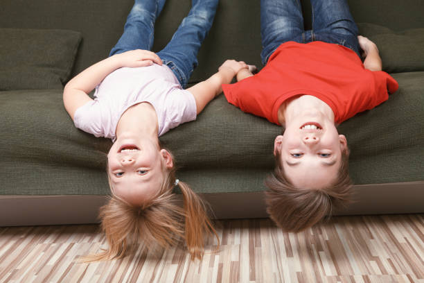 istock Siblings happy staying together at home during self-isolation 1219156048