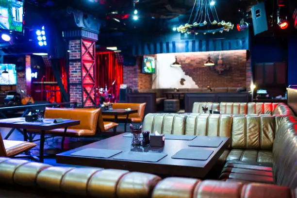 Photo of Interior of Modern Night Club with Lighting and Sound Equipment and Decorated Walls.Horizontal Image