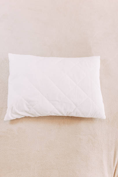 istock White pillow on the bed, beige plaid, stay home while quarantine 1219157877