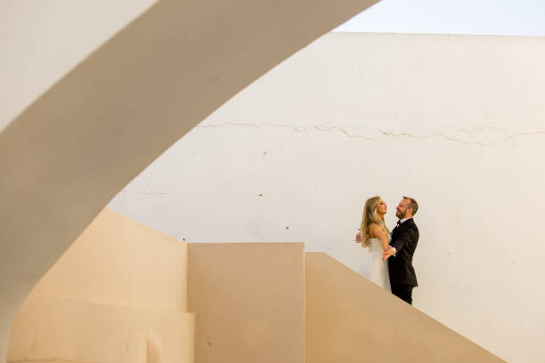 istock Happy wedding couple walking and posing on old streets 1219157899