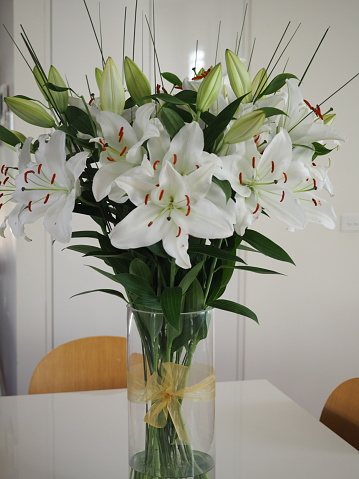 Beautiful, large bunch of white lilies in a vase
