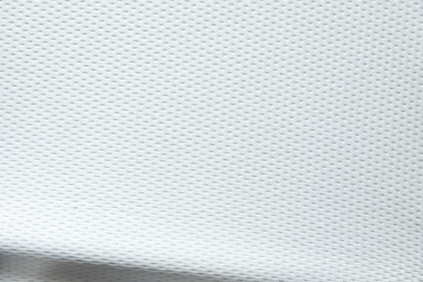 istock Selective focus, White mesh fabric background. cloth sport wear texture for exercise. light weight, good air flow, cool and easy to dry from sweat. abstract wallpaper with copy space for text. 1219159054