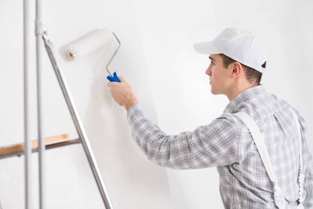 istock Young painter painting a white wall 1219160560