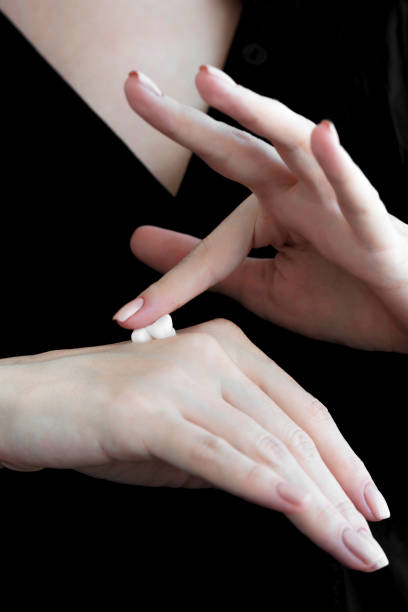 istock A drop of cream on female hands. close-up. 1219160771