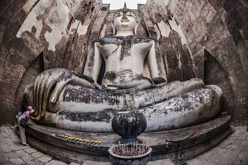 Ancient Buddha statue wearing a cerimonial robe at Yai Chai Mongkhon temple. Ayutthaya. Phra Nakhon Si Ayutthaya province. Thailand.