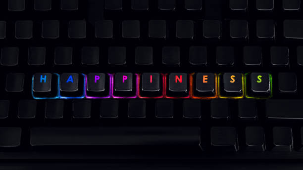 istock Happiness - Written on RGB backlit keyboard, closeup 1219161904