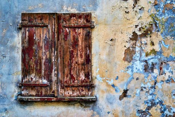 istock old wooden window shutters closeup 1219162248