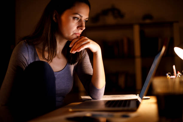 istock Woman working on laptop late at home 1219162809
