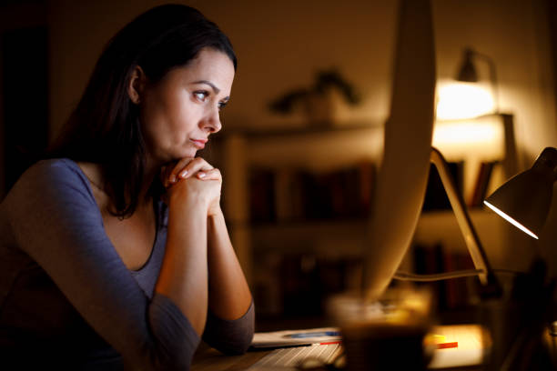 istock Worried, depressed and frustrated woman looking at computer screen 1219162918