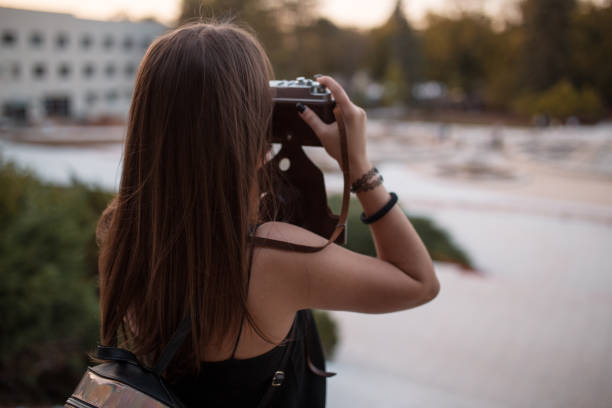 istock Young woman photographer with analog camera 1219163354