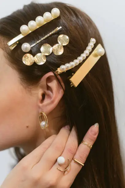 Stylish hairpins for a dark-haired girl. Pearl Earrings.