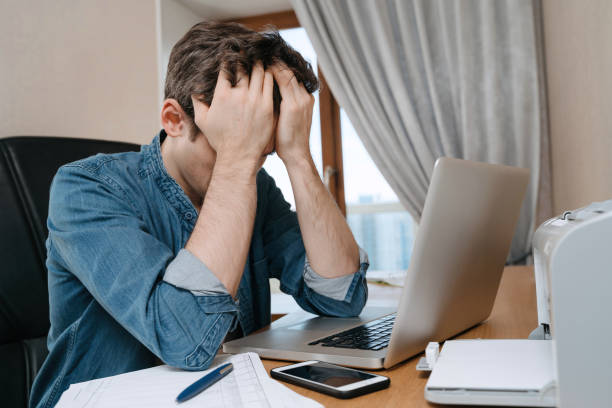 istock Depressed worker with his hands on head in home office 1219167261
