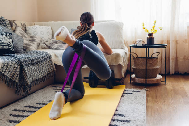 istock Home workout during coronavirus quarantine. Woman training using mat sport belt. Booty glutes building 1219167722