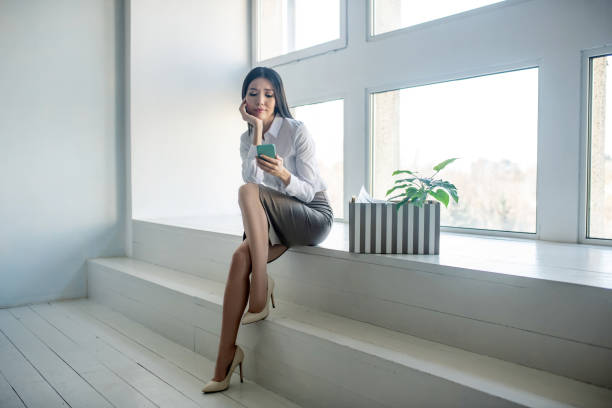 istock Long-haired woman in a white blouse looking worried 1219167924