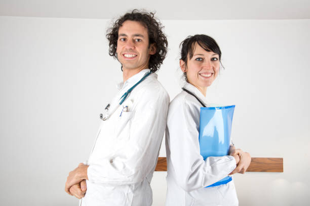 portrait of a young female doctor and a young male doctor stock photo