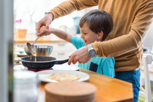 istock Father and son making pancakes together 1219170500