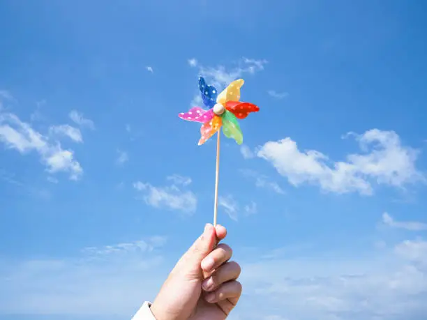 Photo of hand holding pinwheel