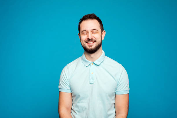 istock man with a beard laughs with closed eyes, joy. A handsome young man smiling 1219172154
