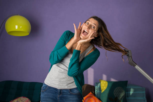 desperate housewife with vacuum cleaner stock photo