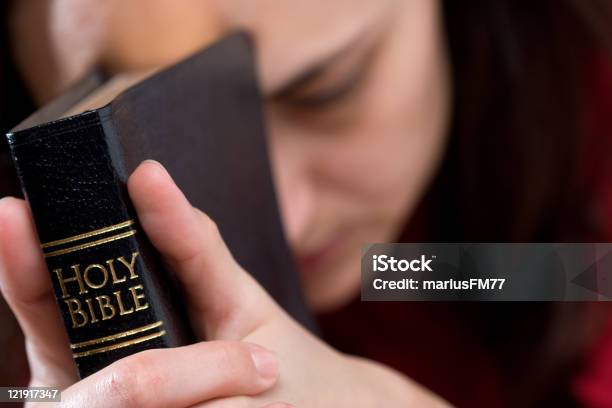 Womans Hands Clasped In Prayer With Holy Bible Stock Photo - Download Image Now - Praying, Religion, Adult