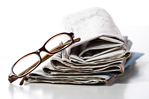 istock pile of newspaper & glasses 121917512