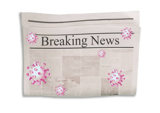 istock Coronavirus Covid-19 news. Newspaper with headline Breaking News on horizontal surface with flying virus 1219175351