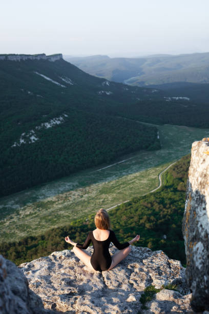 istock Young Girl Practicing Meditation With Mountain View. 1219178844