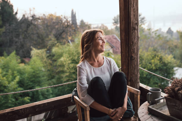 istock Young woman drinking coffee at home 1219181664