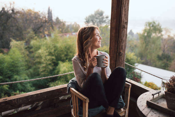 istock Young woman drinking coffee at home 1219181890