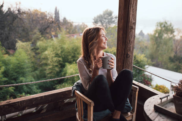 istock Young woman drinking coffee at home 1219181947