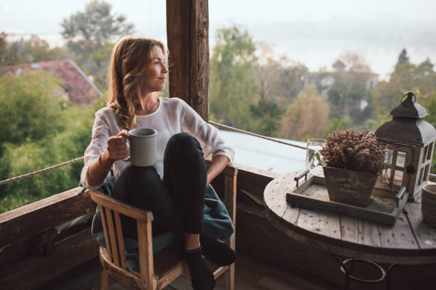 istock Young woman drinking coffee at home 1219182414