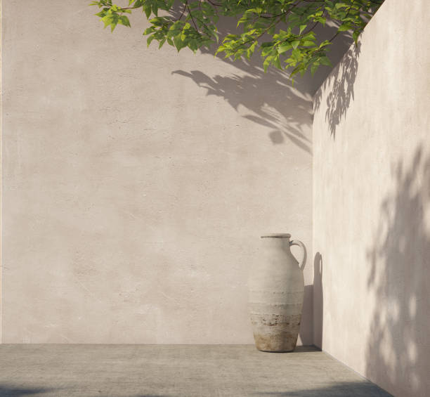 istock Bright white wall with green tropical leaves, sunlight with shadows. Summer, spring background. 3d rendering. 1219182914