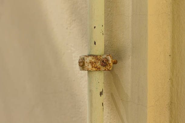 istock Rusty screw of the support of a small pipe on the wall (Pesaro, Italy, Europe) 1219183263