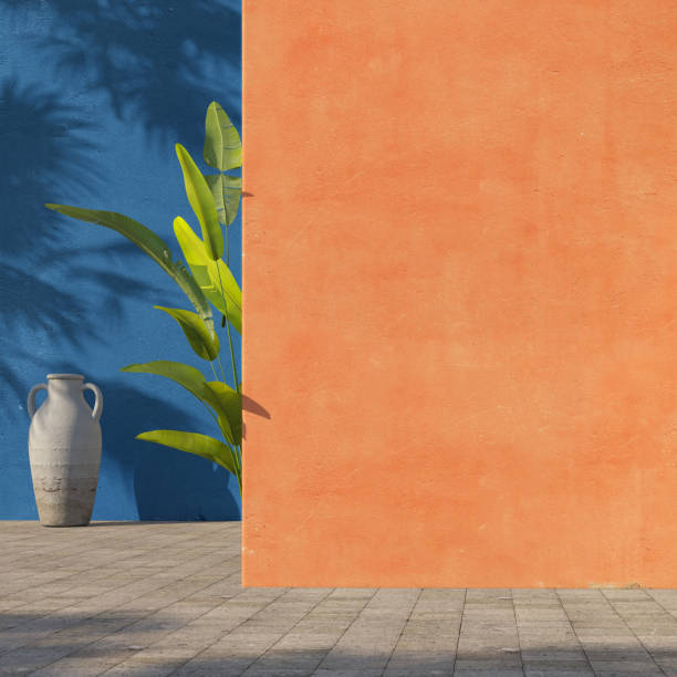 istock Bright painted orange and blue wall with green tropical leaves, sunlight with shadows. Summer, spring background. 3d rendering. 1219183374