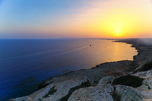 Beautiful sunrise with ship on the sea on Aya Napa, Cyprus