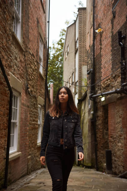 istock Woman in Back Alleyway 1219189429