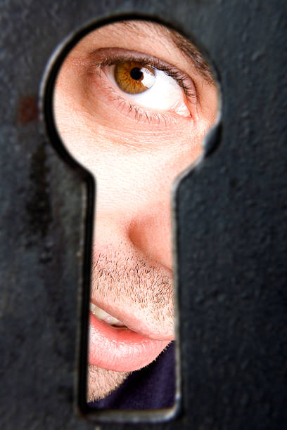 istock I see you! - man looking through keyhole 121919056