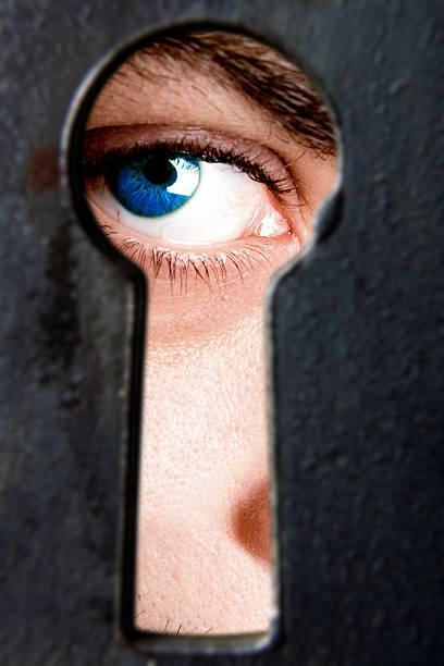 istock I see you! - man looking through keyhole 121919057