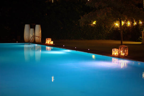 istock night swimming pool and candles 1219190771